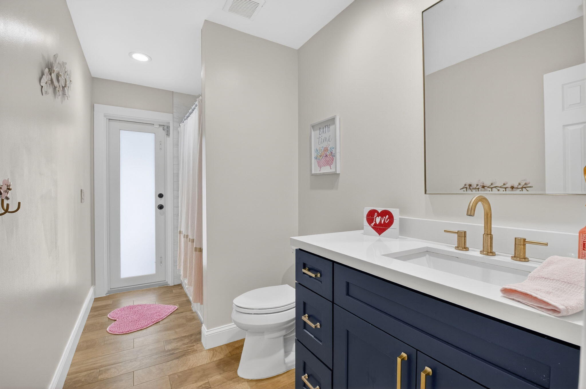 10302 Crosswind Road Boca Raton, FL 33498 - Photo 22 of 27 a bathroom with a sink vanity mirror and toilet