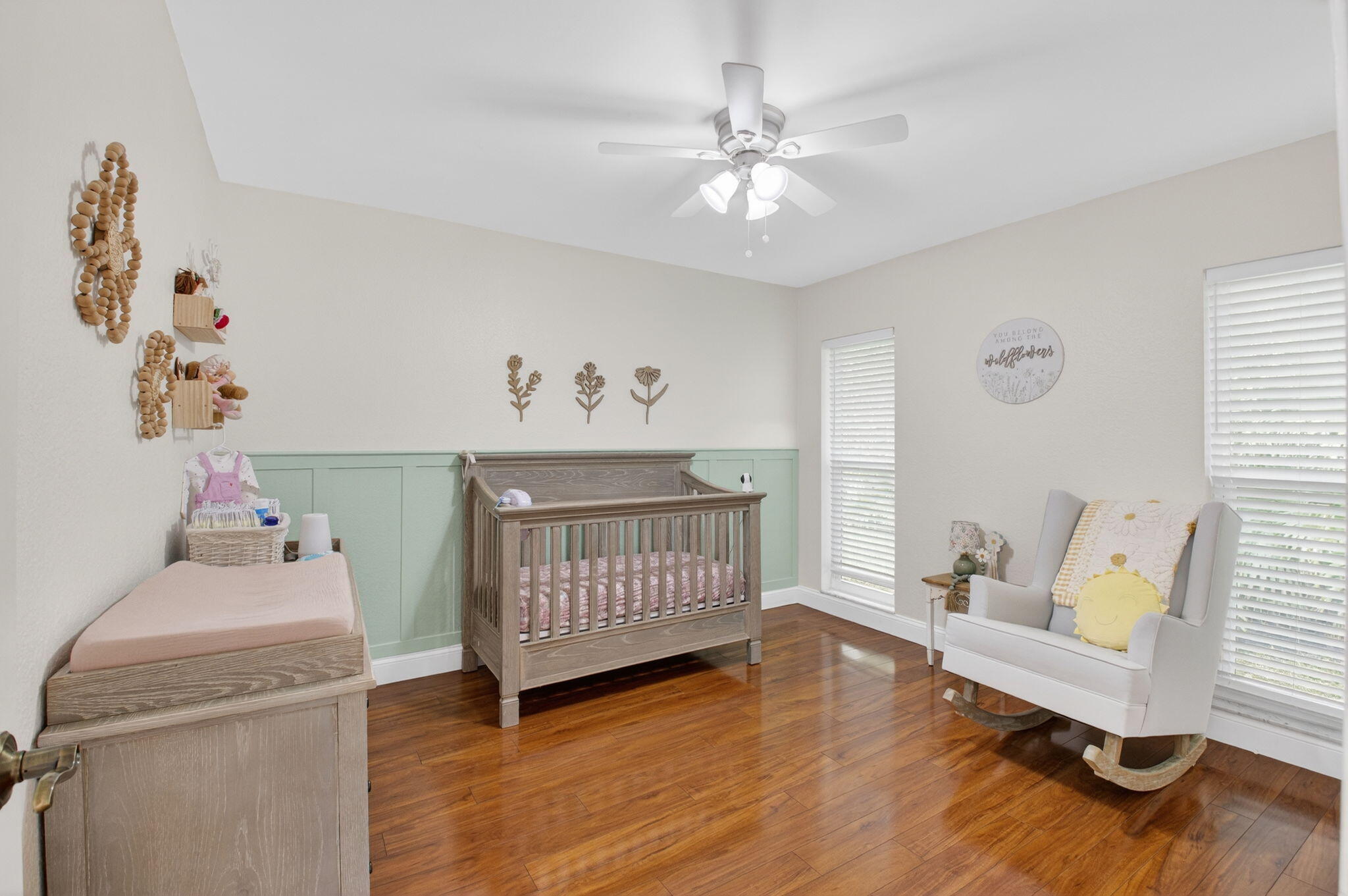 10302 Crosswind Road Boca Raton, FL 33498 - Photo 23 of 27 a bedroom with a baby bed toys and paintings on the wall