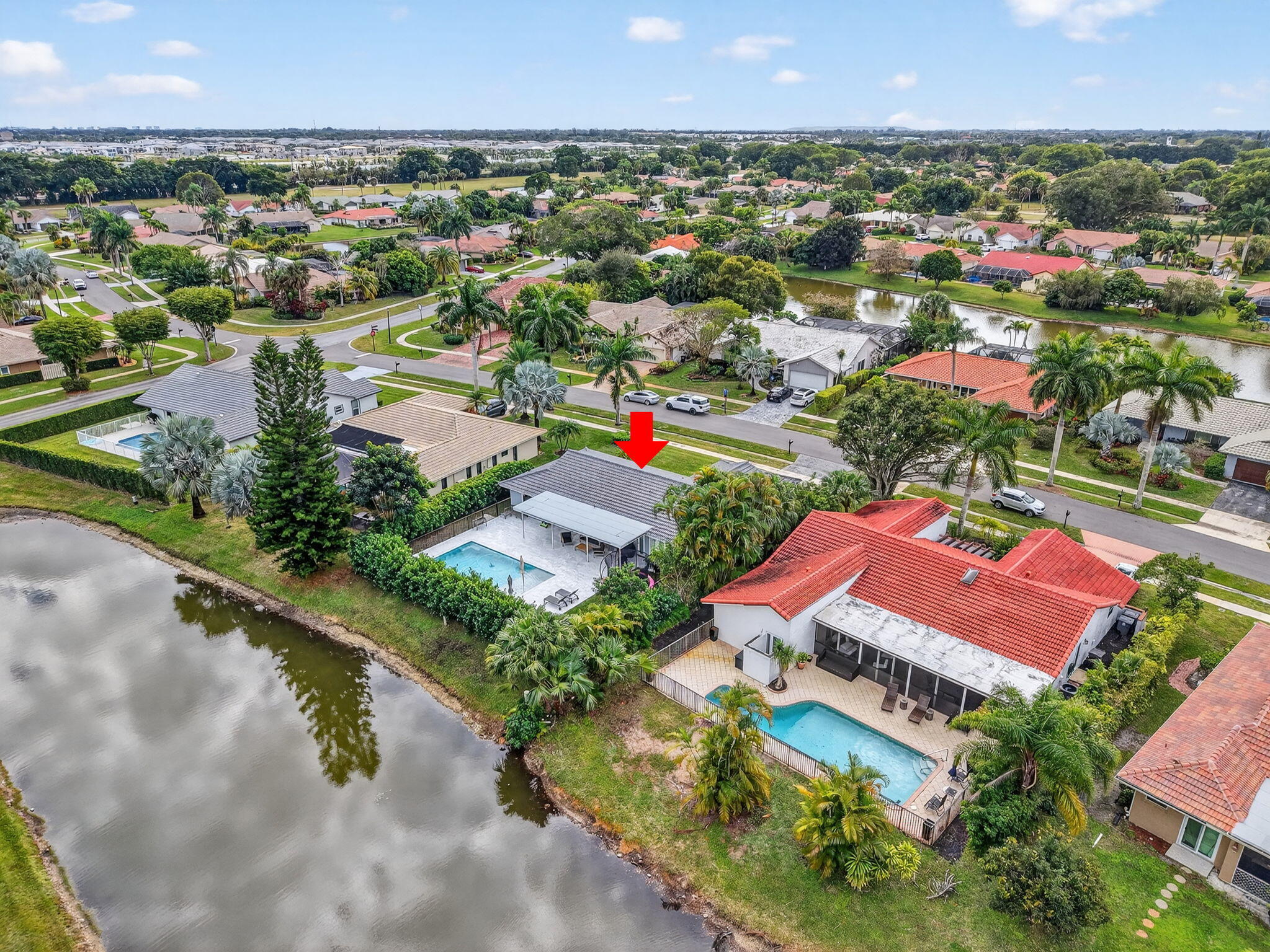 10302 Crosswind Road Boca Raton, FL 33498 - Photo 25 of 27 an aerial view of residential houses with outdoor space and a lake view in back
