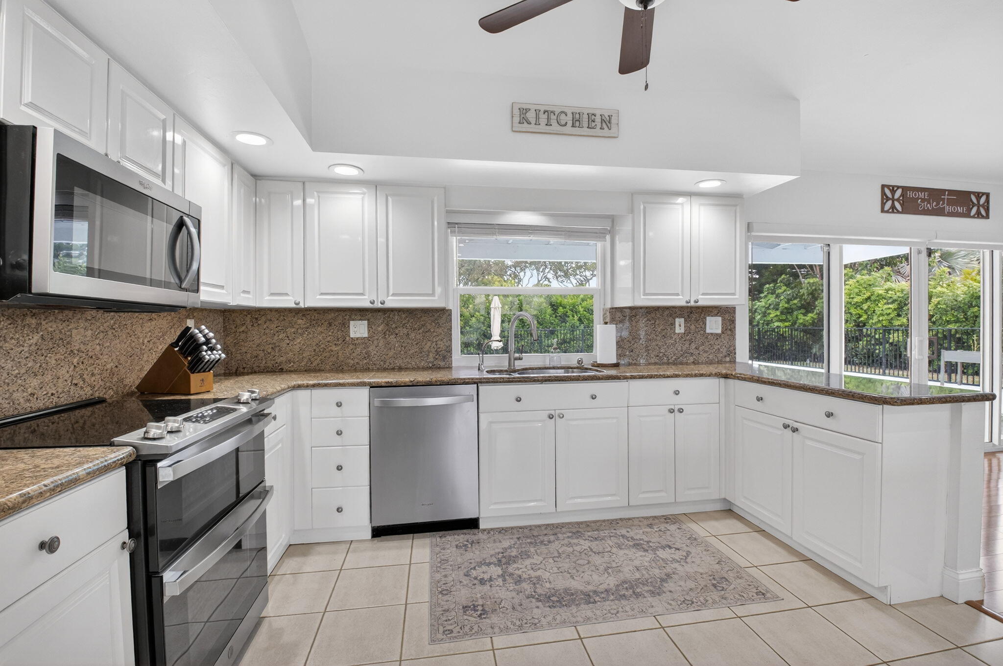 10302 Crosswind Road Boca Raton, FL 33498 - Photo 9 of 27 a kitchen with a sink cabinets and window