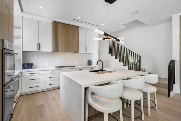 a kitchen with a stove a table and chairs