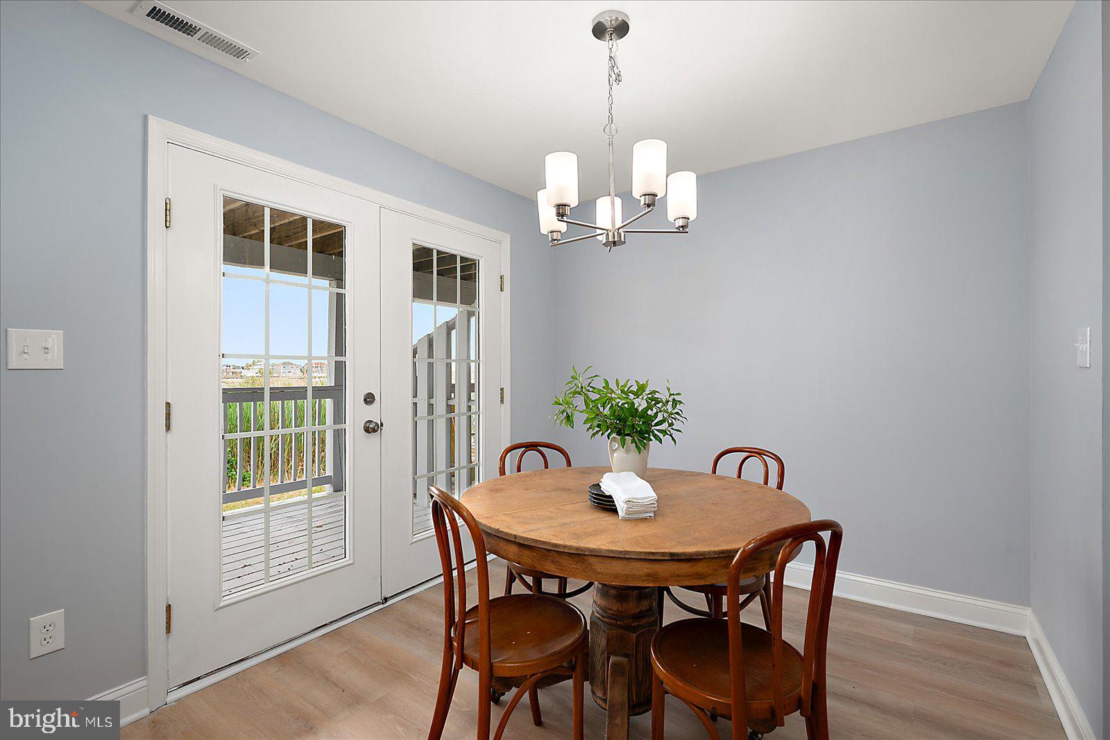 135 Jamestown Road, Unit 18A Ocean City, MD 21842 - Photo 24 of 63 a view of a dining room with furniture window and wooden floor
