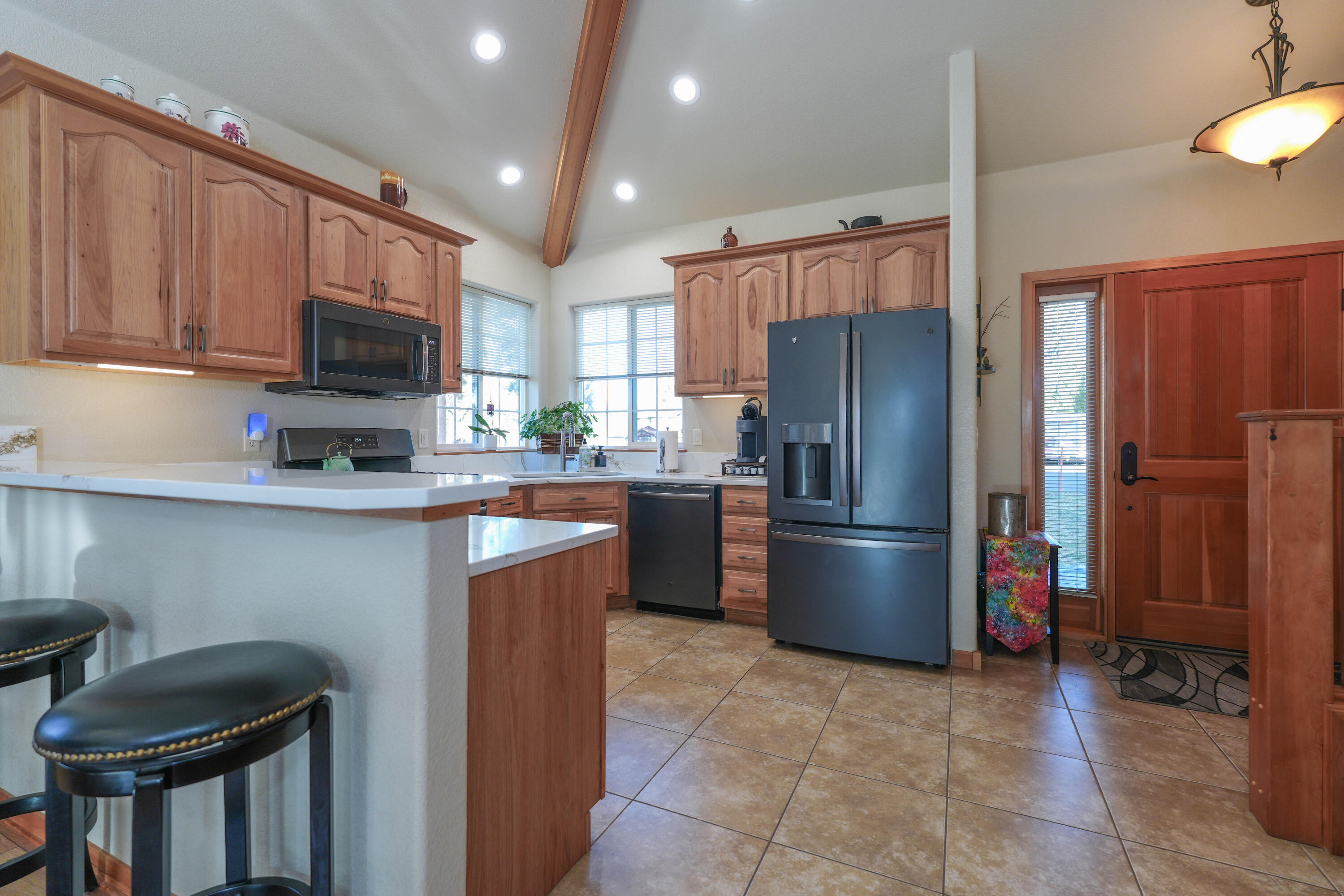 5028 Sora Loop Klamath Falls, OR 97601 - Photo 12 of 62 a kitchen with stainless steel appliances granite countertop a refrigerator stove and microwave