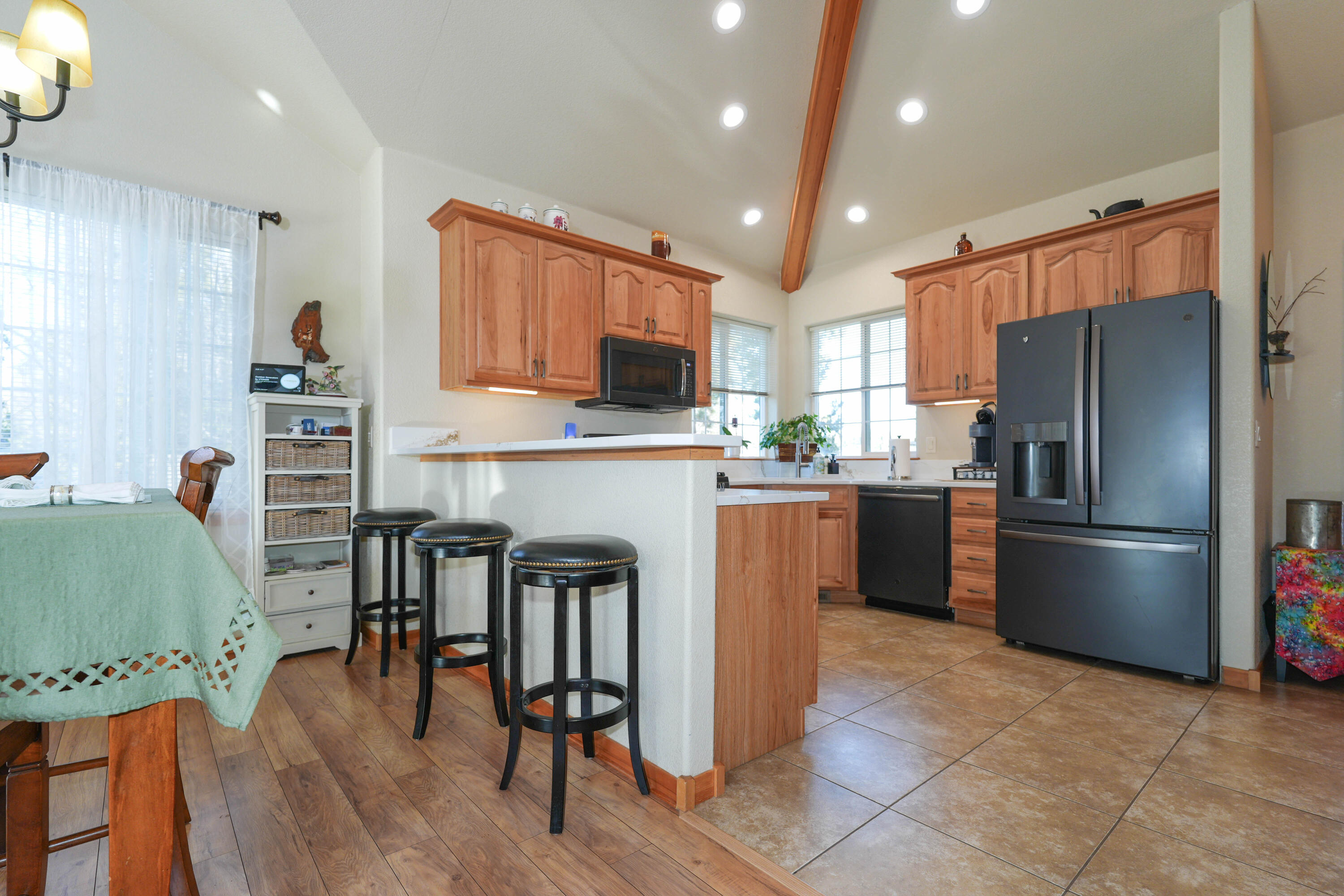 5028 Sora Loop Klamath Falls, OR 97601 - Photo 19 of 62 a kitchen with stainless steel appliances a refrigerator a stove a sink a dining table and chairs