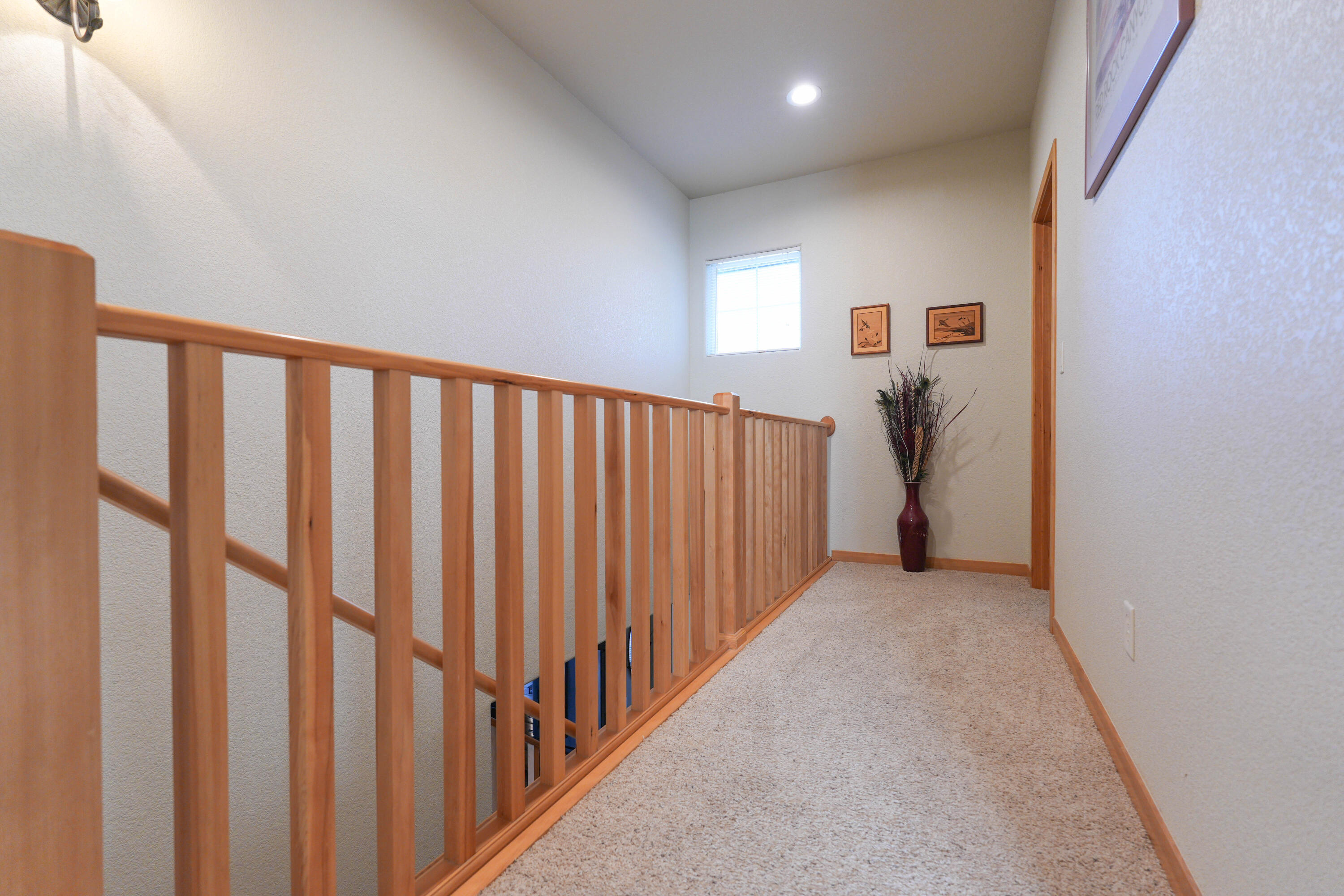 5028 Sora Loop Klamath Falls, OR 97601 - Photo 40 of 62 a view of a hallway with wooden floor and stairs