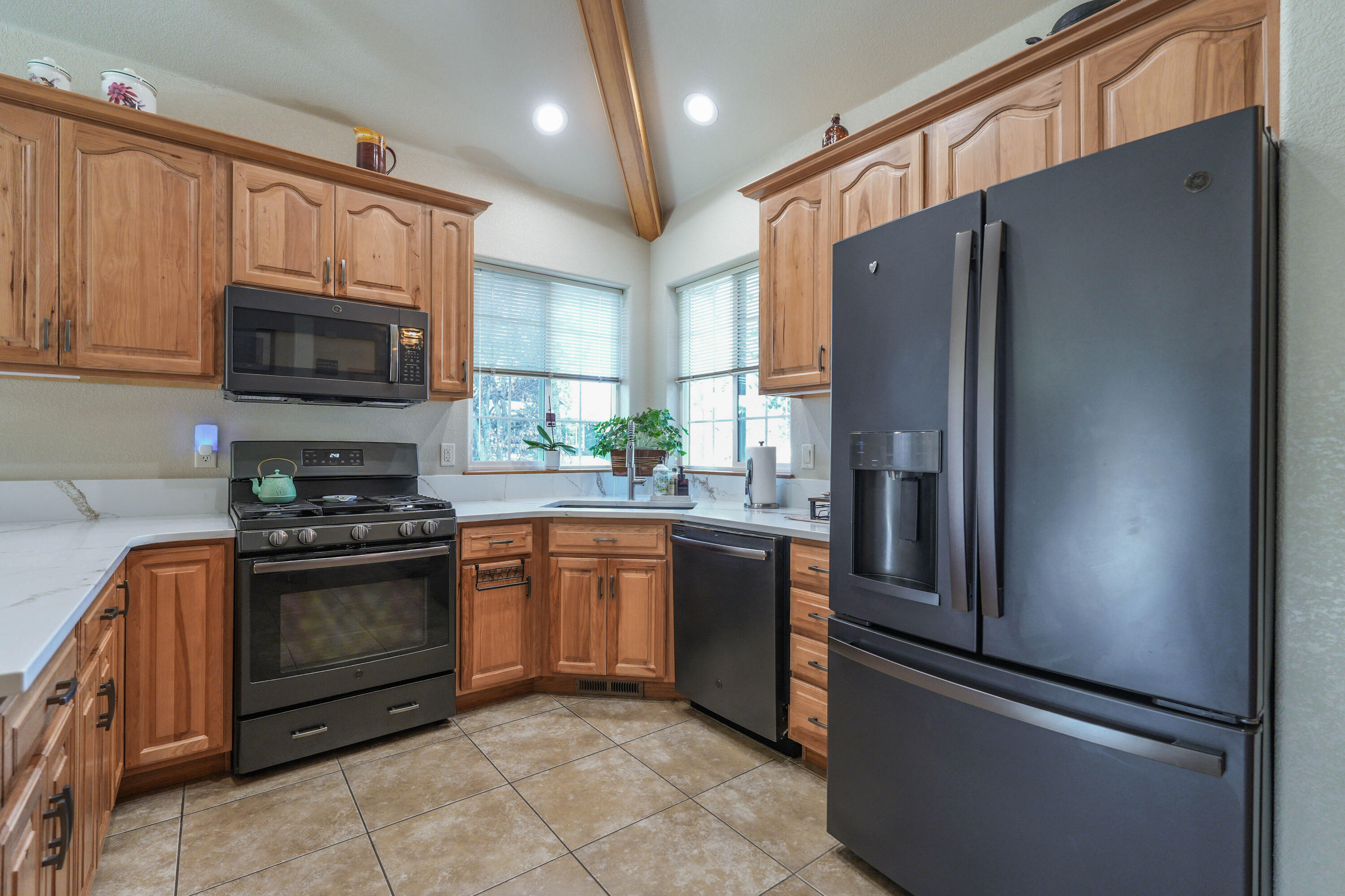 5028 Sora Loop Klamath Falls, OR 97601 - Photo 8 of 62 a kitchen with stainless steel appliances granite countertop a refrigerator stove and microwave