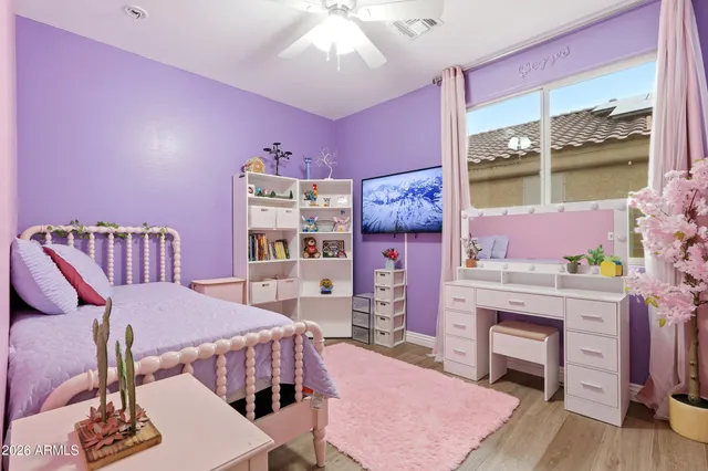 a bathroom with a granite countertop sink and a toilet