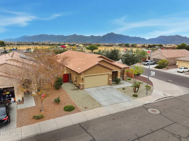 an aerial view of residential houses with outdoor space and ocean view