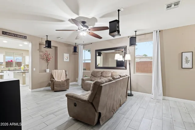 a living room with furniture and wooden floor