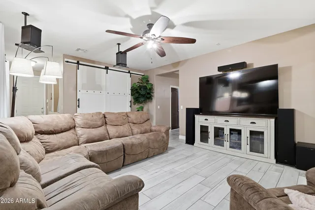 a kitchen with a dining table chairs and refrigerator
