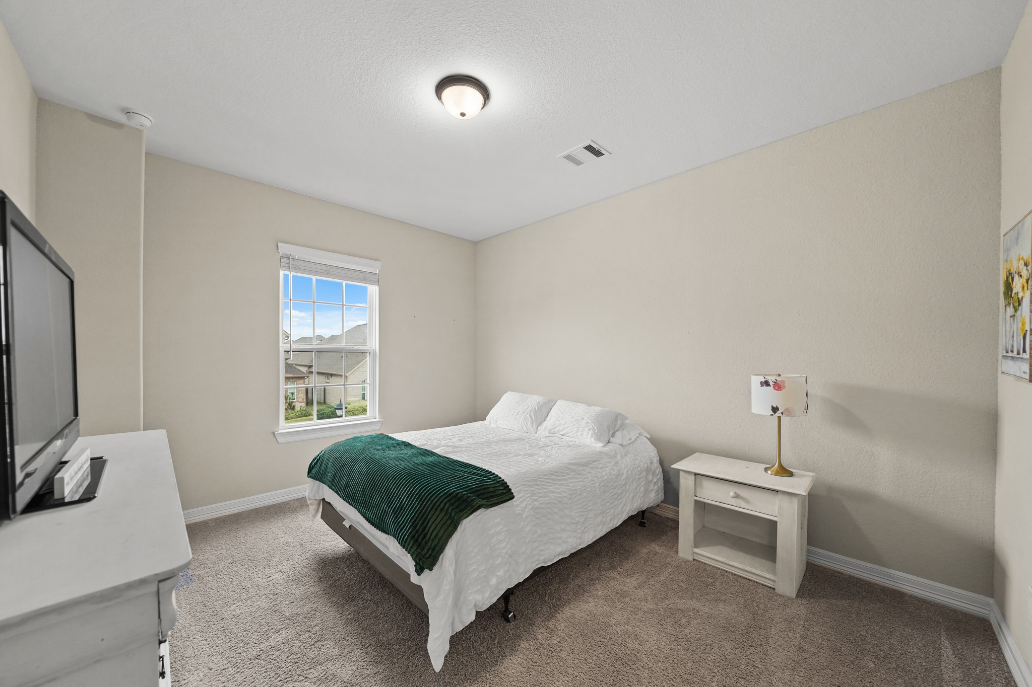 24031 Corinaldo Court Katy, TX 77493 - Photo 16 of 23 a bedroom with a bed and a flat screen tv