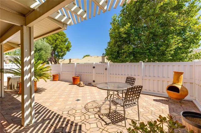 a view of a patio with table and chairs potted plants