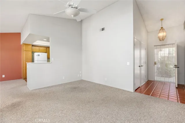 an empty room with windows and mirror