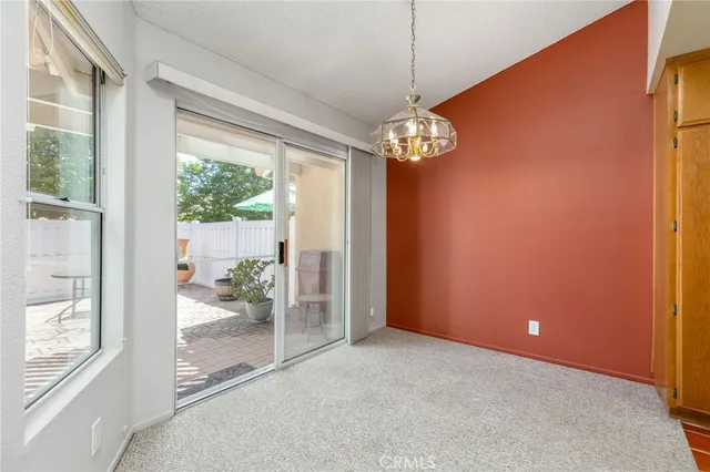 a view of a livingroom with a chandelier couches and chairs