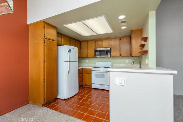 a kitchen with refrigerator cabinets and a sink