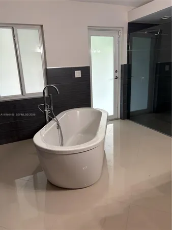 a white bath tub sitting in a bathroom