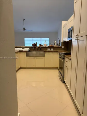 a kitchen with stainless steel appliances a refrigerator stove top oven and sink