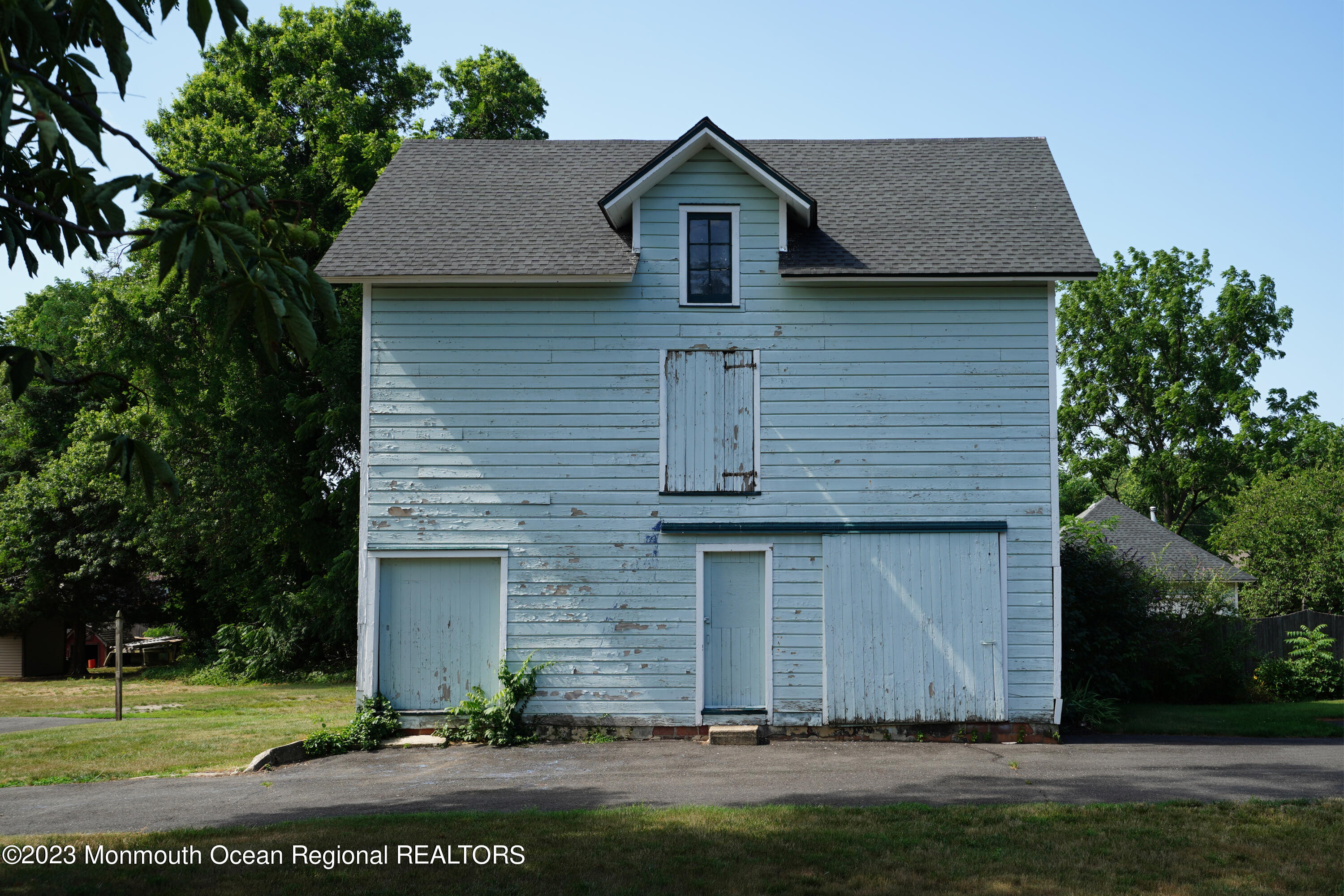 51 Cherry Tree Farm Road Middletown, NJ 07748 - Photo 13 of 62 a front view of a house with a yard and garage