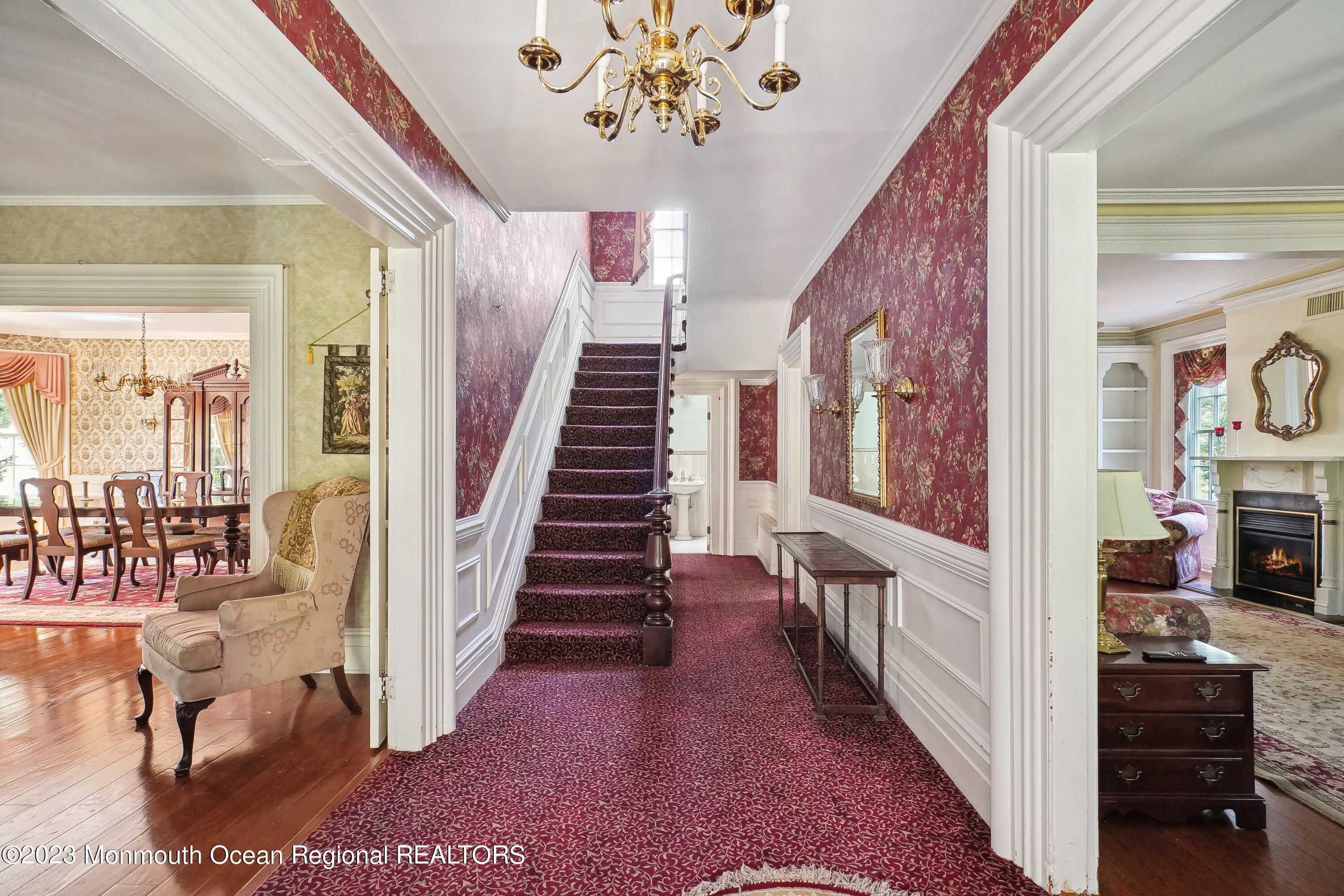51 Cherry Tree Farm Road Middletown, NJ 07748 - Photo 24 of 62 a view of a hallway to a livingroom with wooden floor and a chandelier