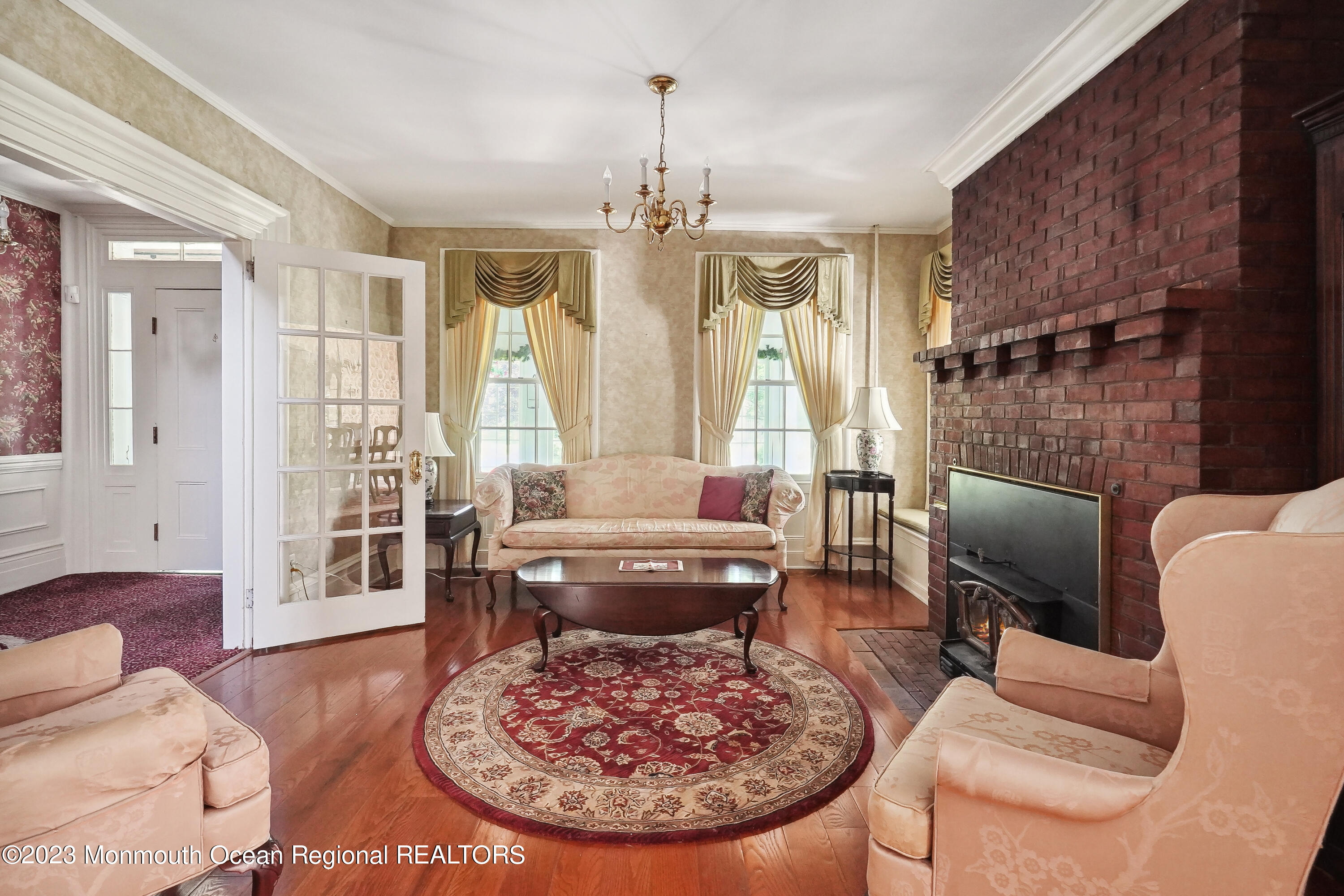 51 Cherry Tree Farm Road Middletown, NJ 07748 - Photo 26 of 62 a living room with furniture a lamp and a chandelier