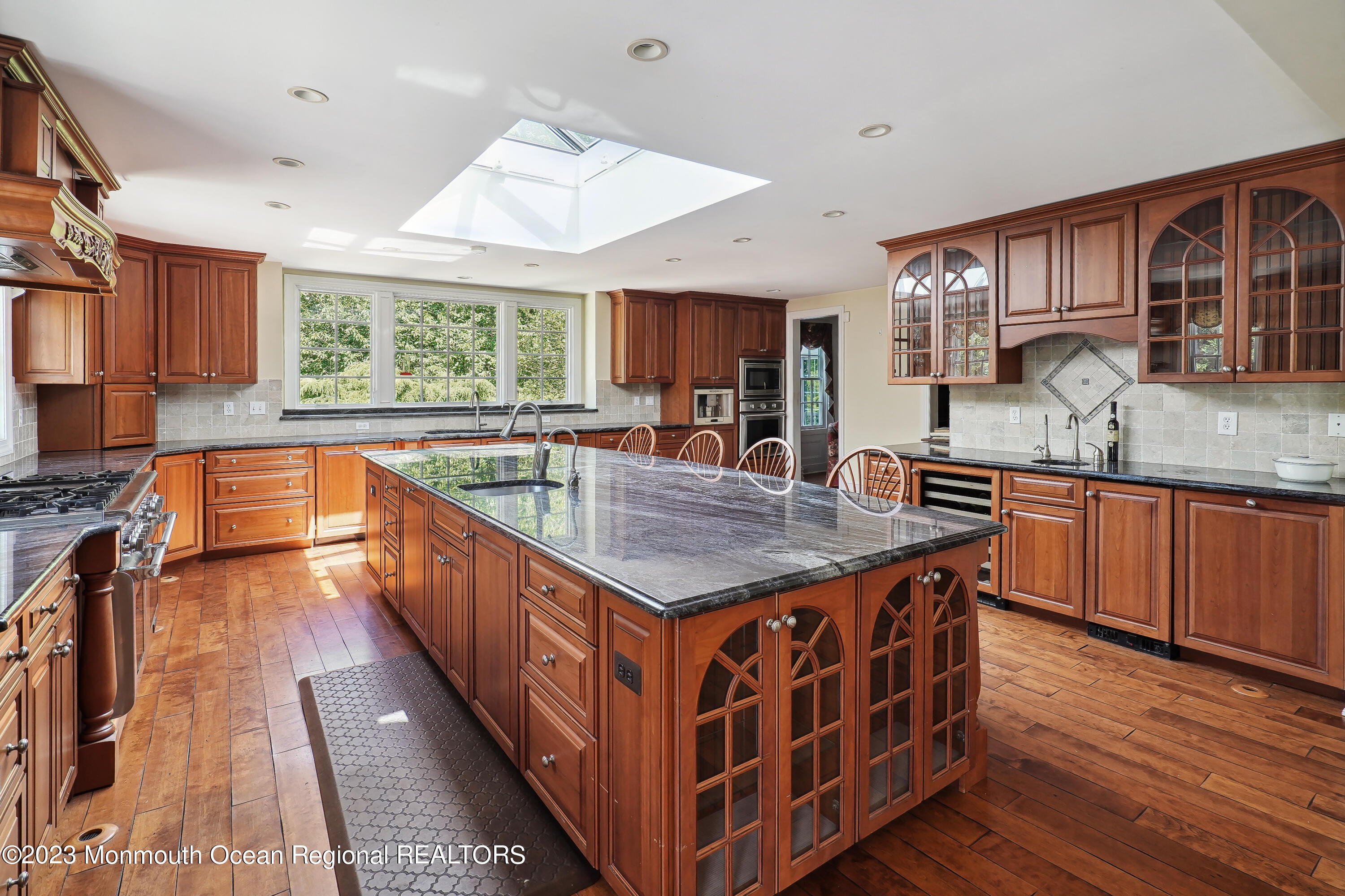 51 Cherry Tree Farm Road Middletown, NJ 07748 - Photo 34 of 62 a kitchen with stainless steel appliances granite countertop a sink a counter space and wooden floor
