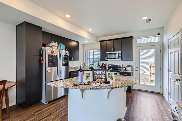 a kitchen with refrigerator and cabinets