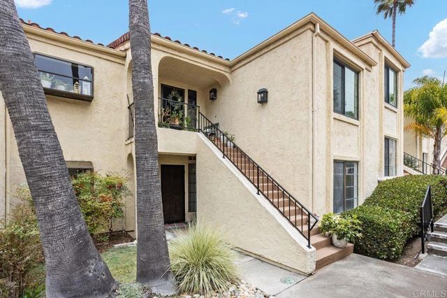 a view of a house with more windows and plants