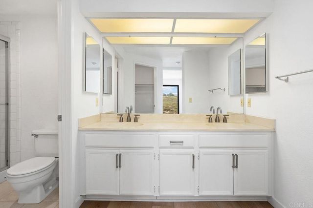 a bathroom with a sink a toilet and a mirror