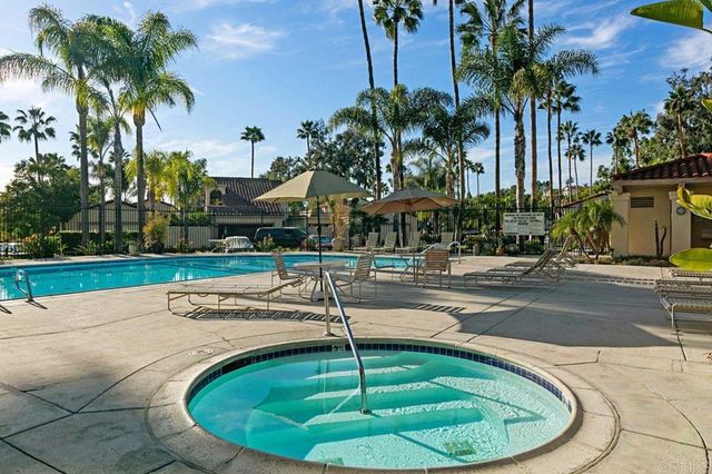 a swimming pool with outdoor seating and yard