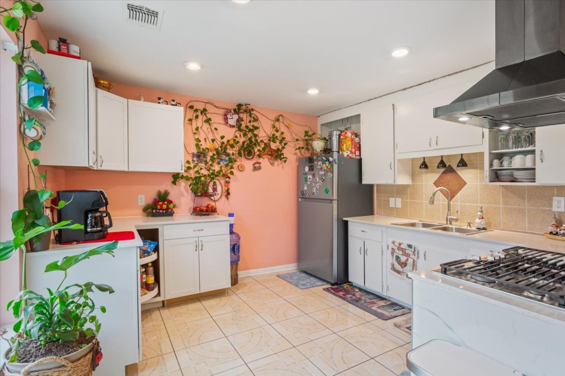 50 Dusty Dam Road Coupland, TX 78615 - Photo 11 of 38 The kitchen is designed for practicality and connection, offering ample counter space and cabinetry.