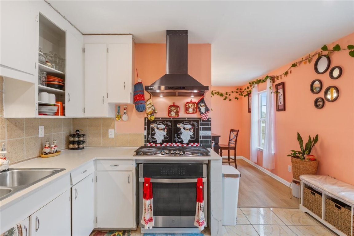50 Dusty Dam Road Coupland, TX 78615 - Photo 13 of 38 Natural light enhances the workspace, making the kitchen feel open and functional.