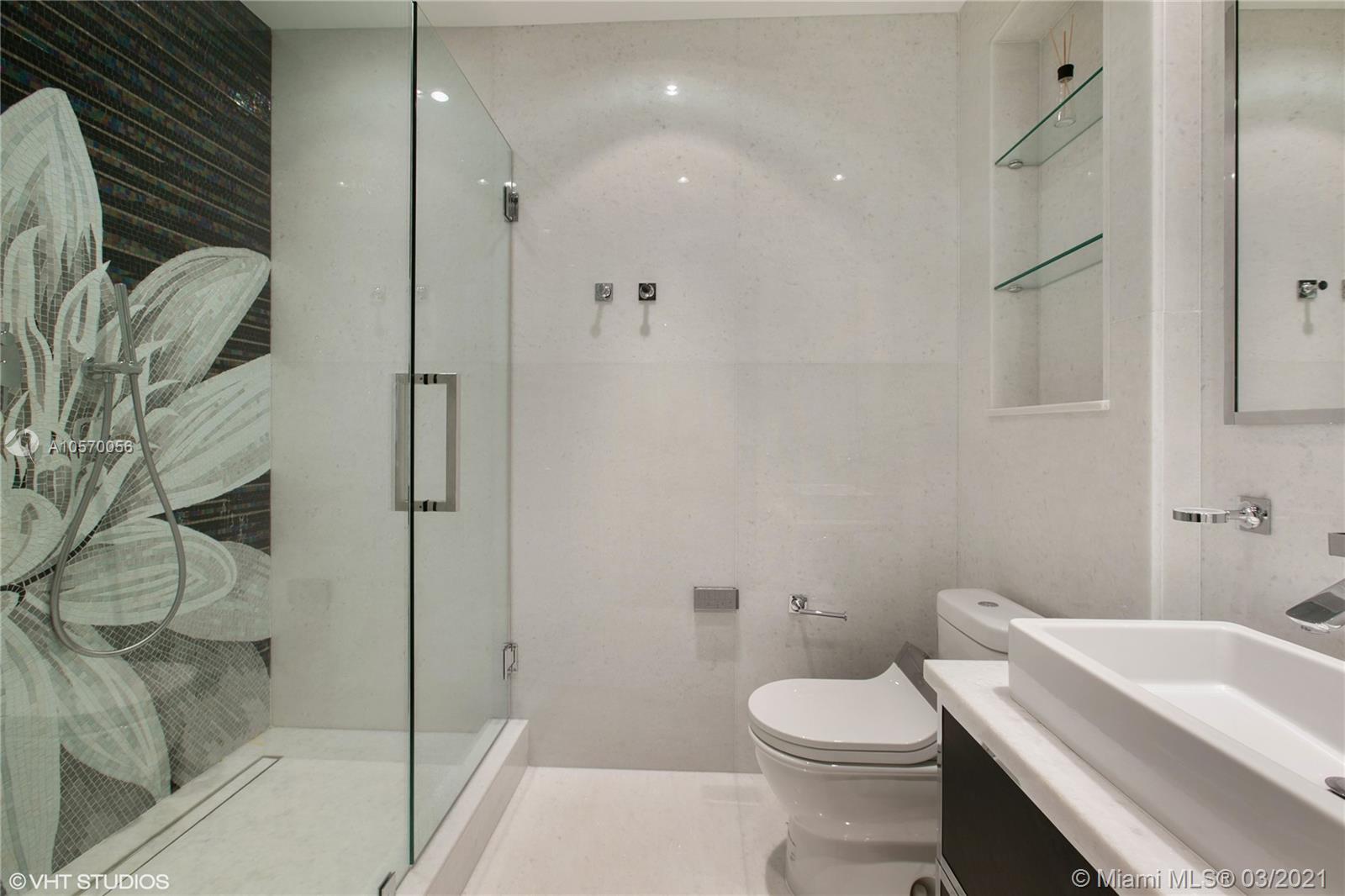 9703 Collins Avenue, Unit PH07 Bal Harbour, FL 33154 - Photo 14 of 23 a bathroom with a sink a toilet and shower