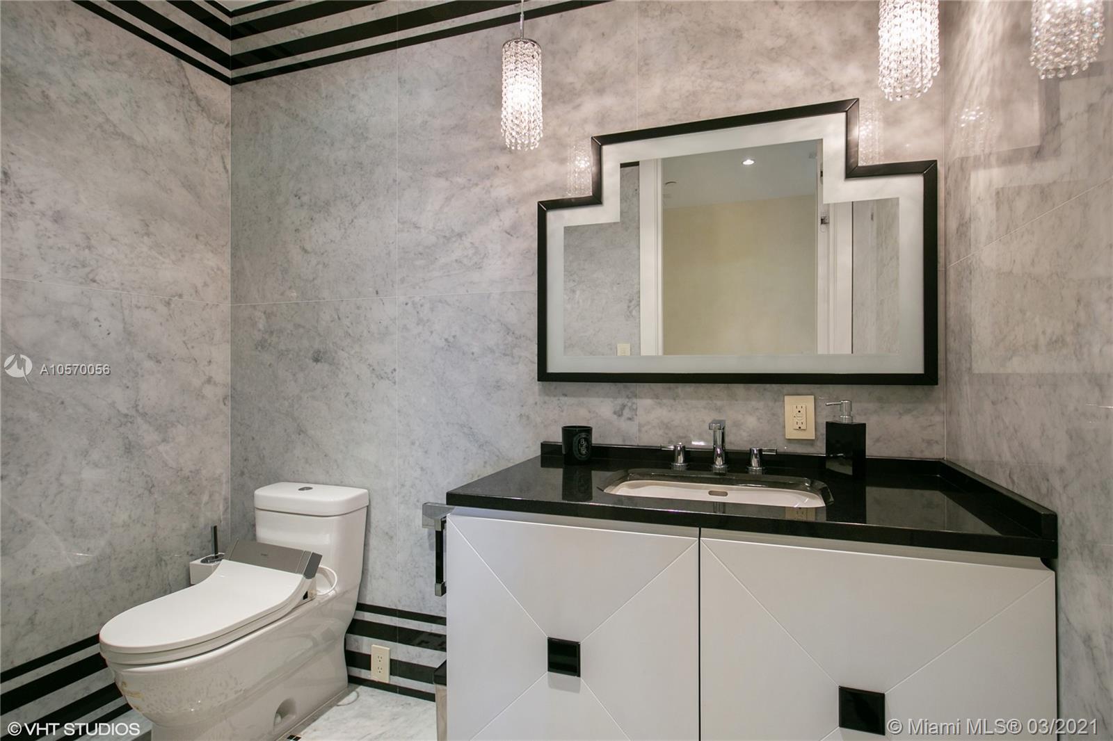 9703 Collins Avenue, Unit PH07 Bal Harbour, FL 33154 - Photo 15 of 23 a bathroom with a sink a toilet and mirror