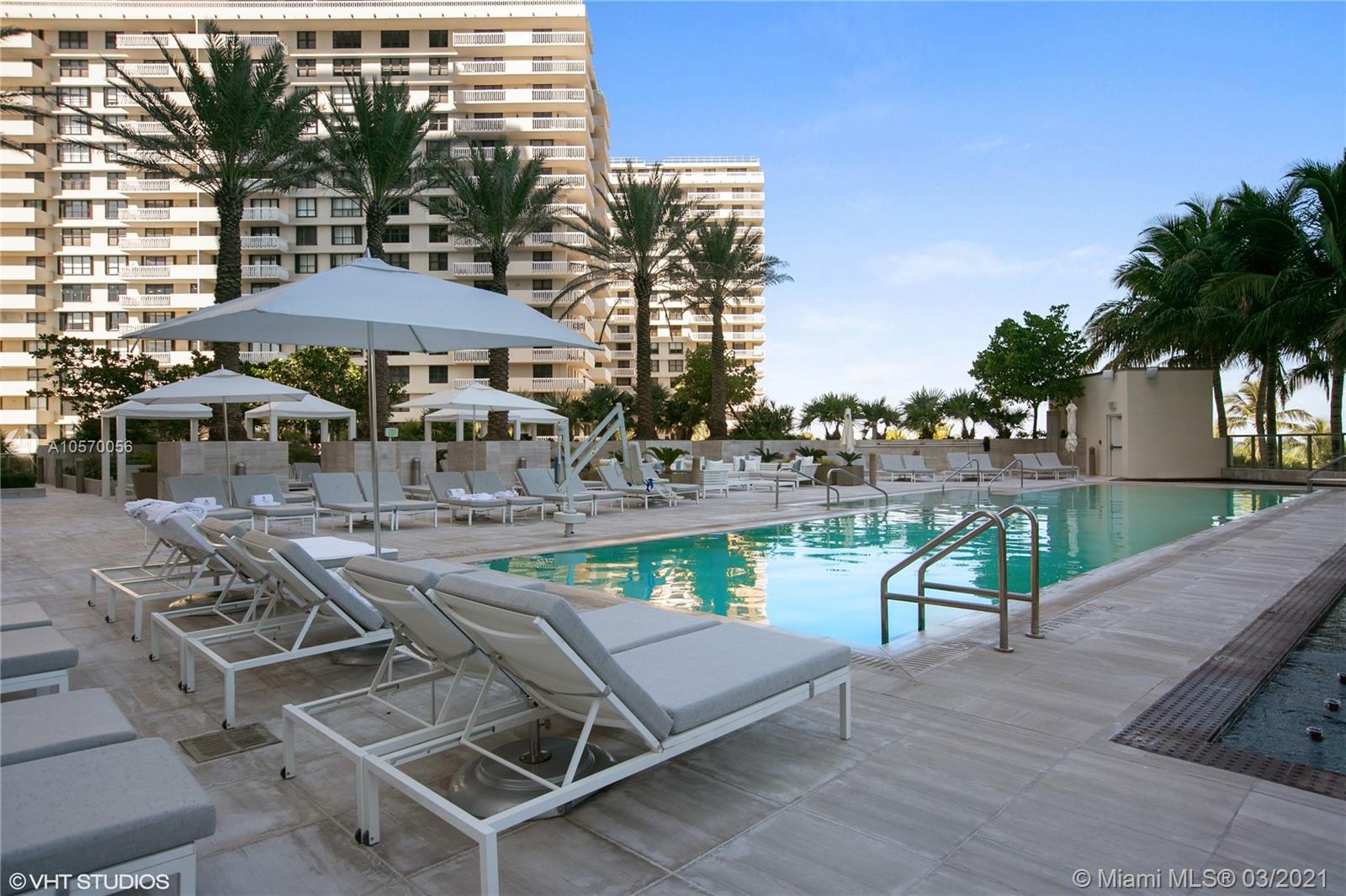 9703 Collins Avenue, Unit PH07 Bal Harbour, FL 33154 - Photo 18 of 23 an outdoor space with furniture and umbrella