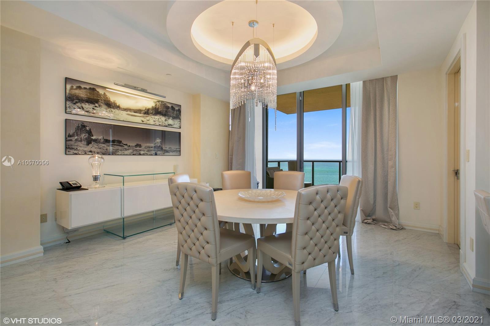 9703 Collins Avenue, Unit PH07 Bal Harbour, FL 33154 - Photo 7 of 23 a dining room with furniture a chandelier and window