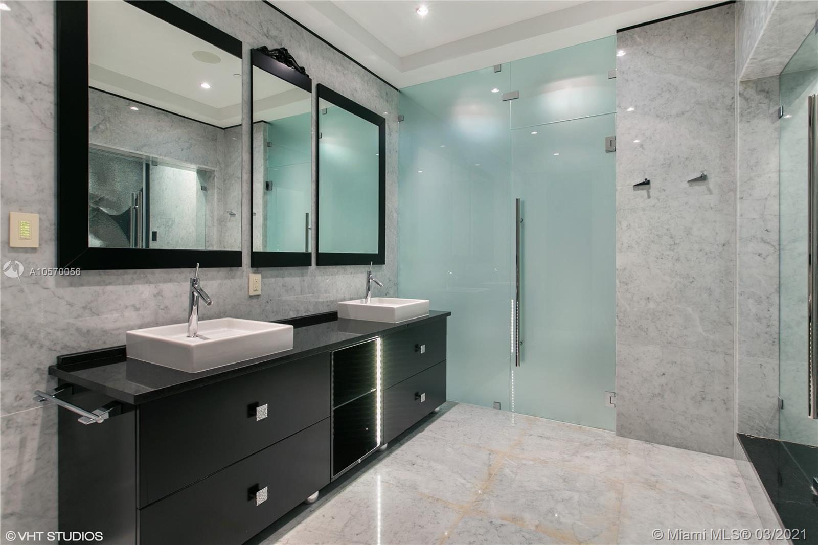 9703 Collins Avenue, Unit PH07 Bal Harbour, FL 33154 - Photo 10 of 23 a bathroom with a sink and a mirror