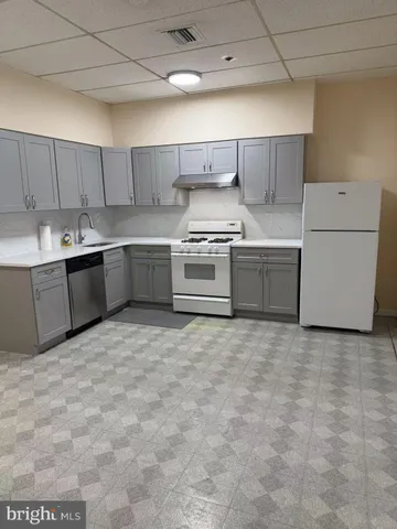 a kitchen with a stove top oven sink and cabinets