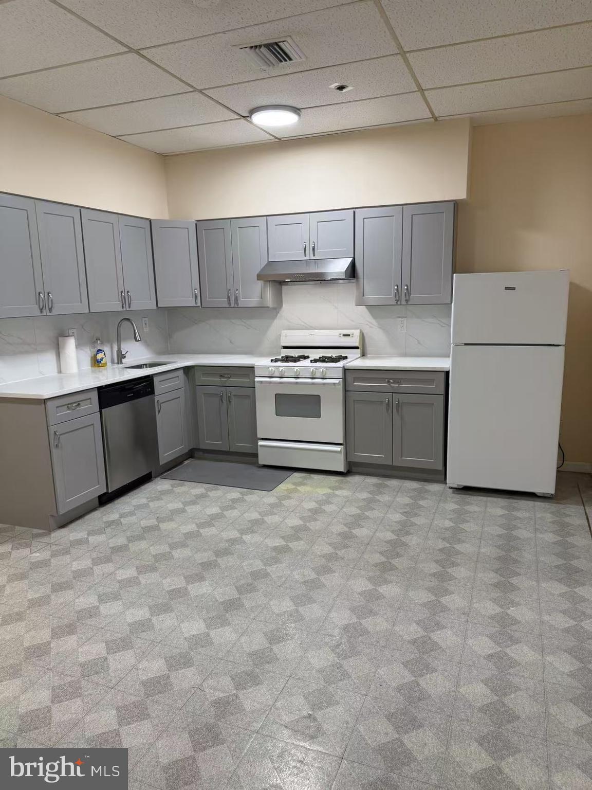 1009 Arch Street, Unit 4B Philadelphia, PA 19107 - Photo 4 of 4 a kitchen with a stove top oven sink and cabinets