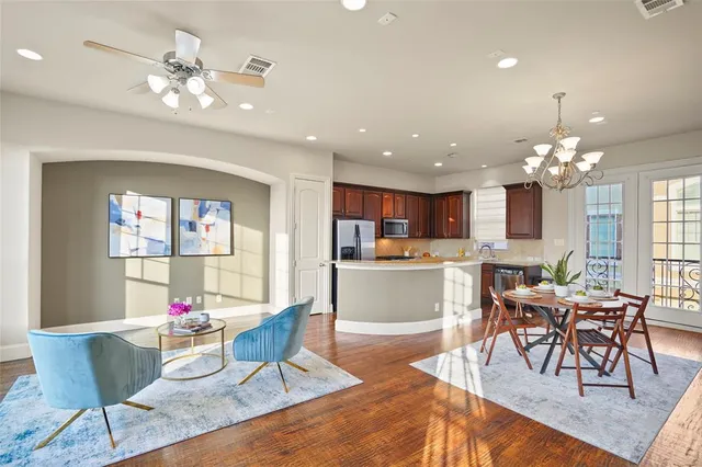 a living room with dining room and kitchen view