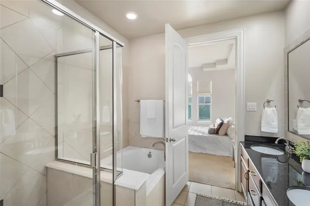 a bathroom with a tub shower and sink