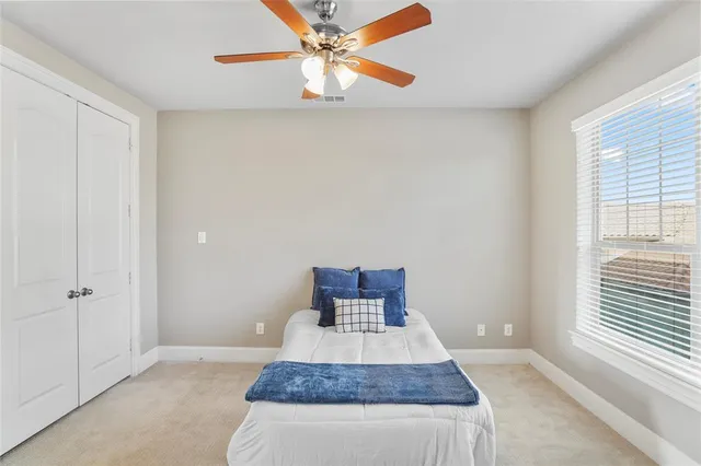 a bedroom with a bed and a window