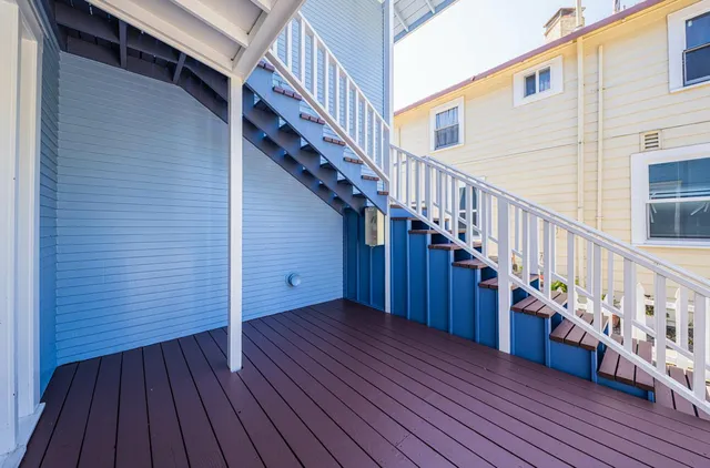 a view of a house with backyard and deck