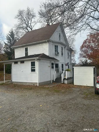 a view of a house with a yard and garage