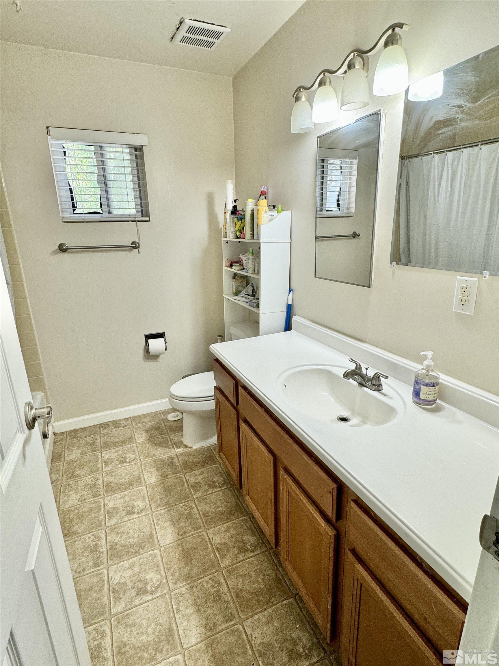 3915 Covington Way Reno, NV 89503 - Photo 13 of 17 a bathroom with a sink a toilet and mirror