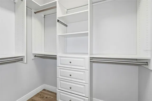 a spacious bathroom with a double vanity sink a mirror a bathtub and shower