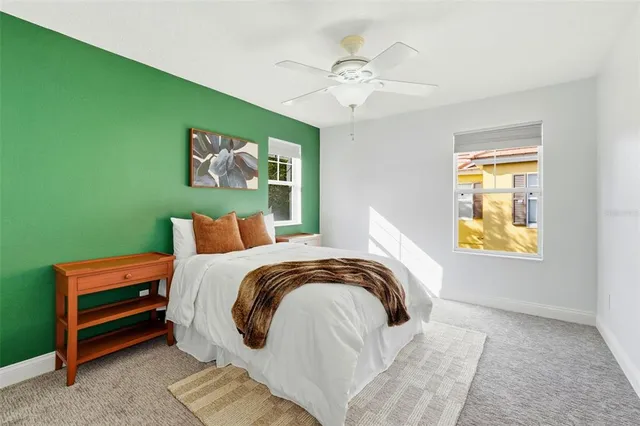 a bedroom with a large bed and a chandelier