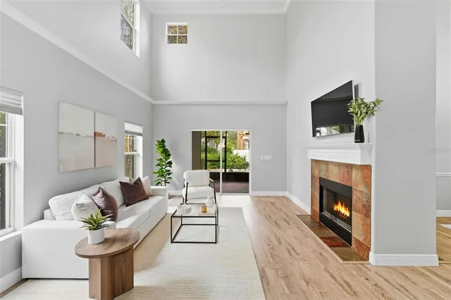 a living room with furniture a fireplace and a flat screen tv