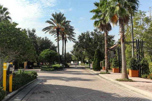 a kitchen with stainless steel appliances a dining table chairs and a refrigerator