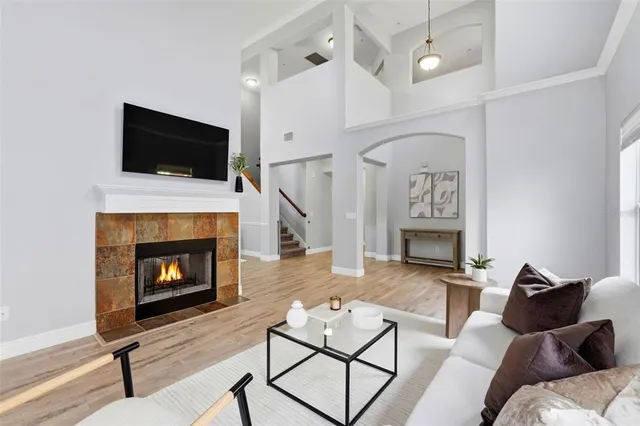 a living room with furniture a flat screen tv and a fireplace
