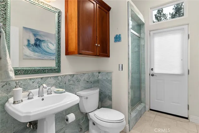 a spacious bathroom with a granite countertop tub a mirror a window and a potted plant